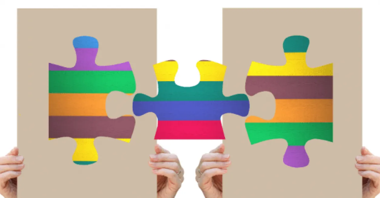 Colorful puzzle pieces being held up